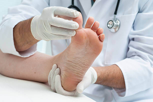 Podiatrist examines the foot on the presence of athlete's foot