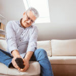 Senior man suffering with foot cramp problem