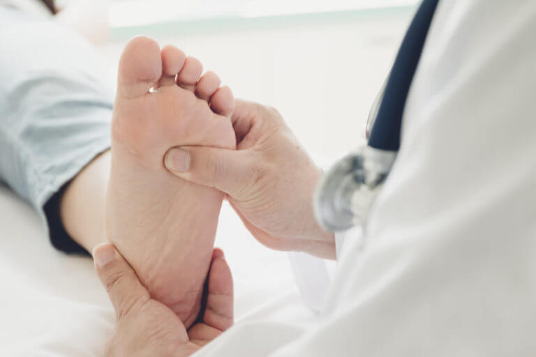 foot doctor checking patient foot in Foot clinic